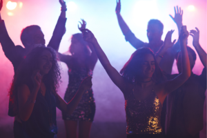 Students dancing in a darkly lit night club