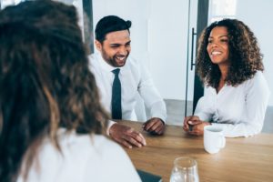 Two interviews look happy in front of candidate