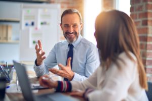 Two people laughing in meeting