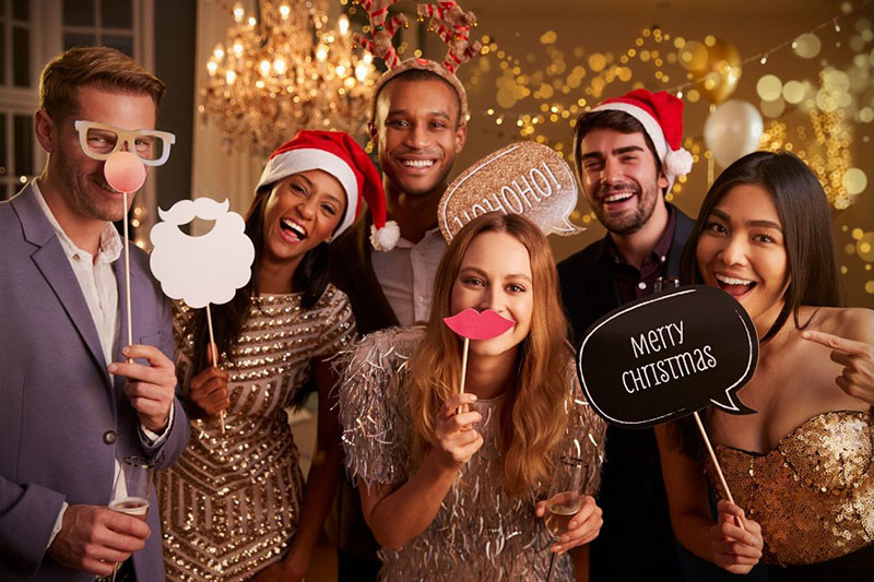 Colleagues posing with christmas related props
