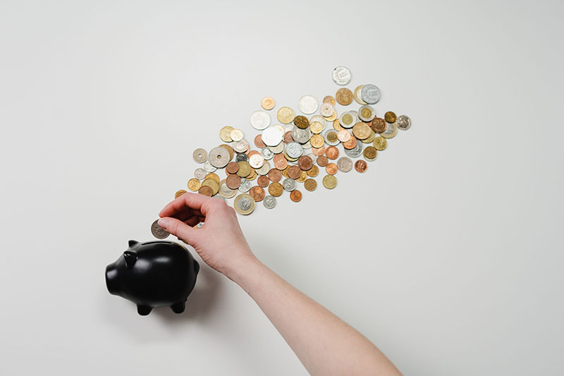 Coins falling out of a piggy bank
