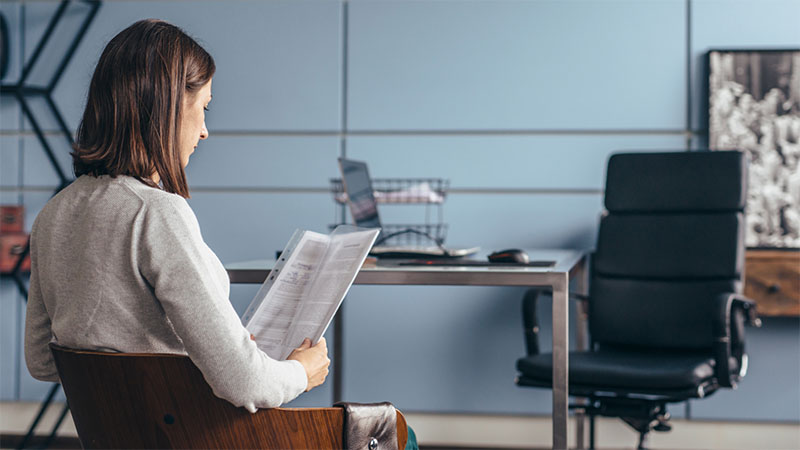 Person sat reading a CV