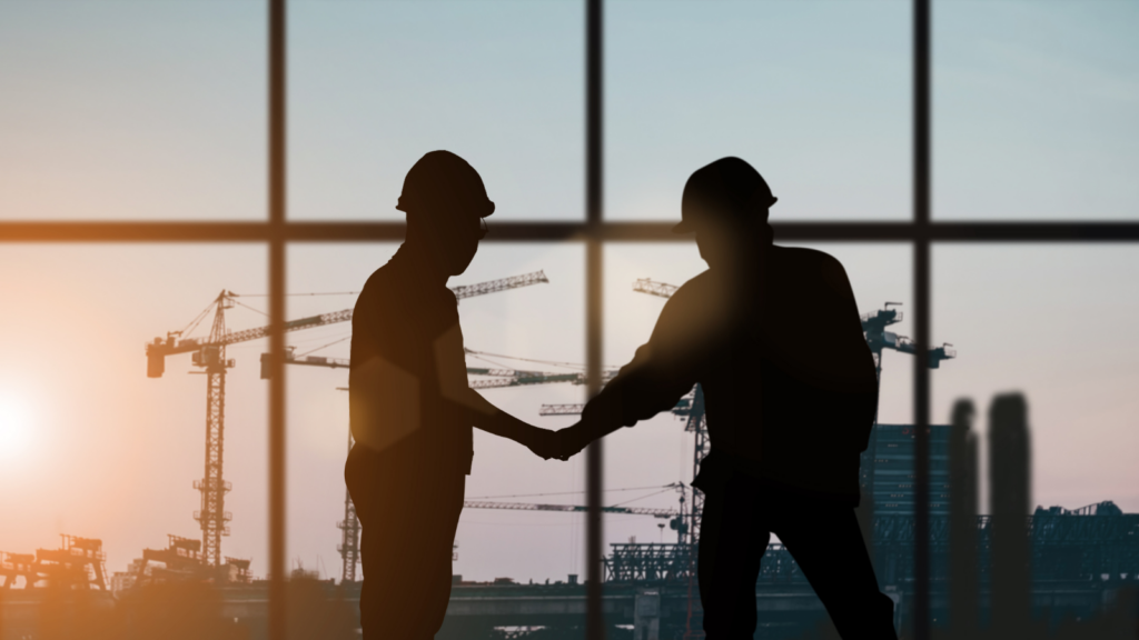 Two men shaking hands on a construction site