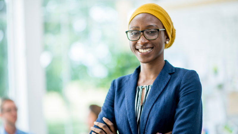 Professional woman with folded arms, smiling and facing forwards