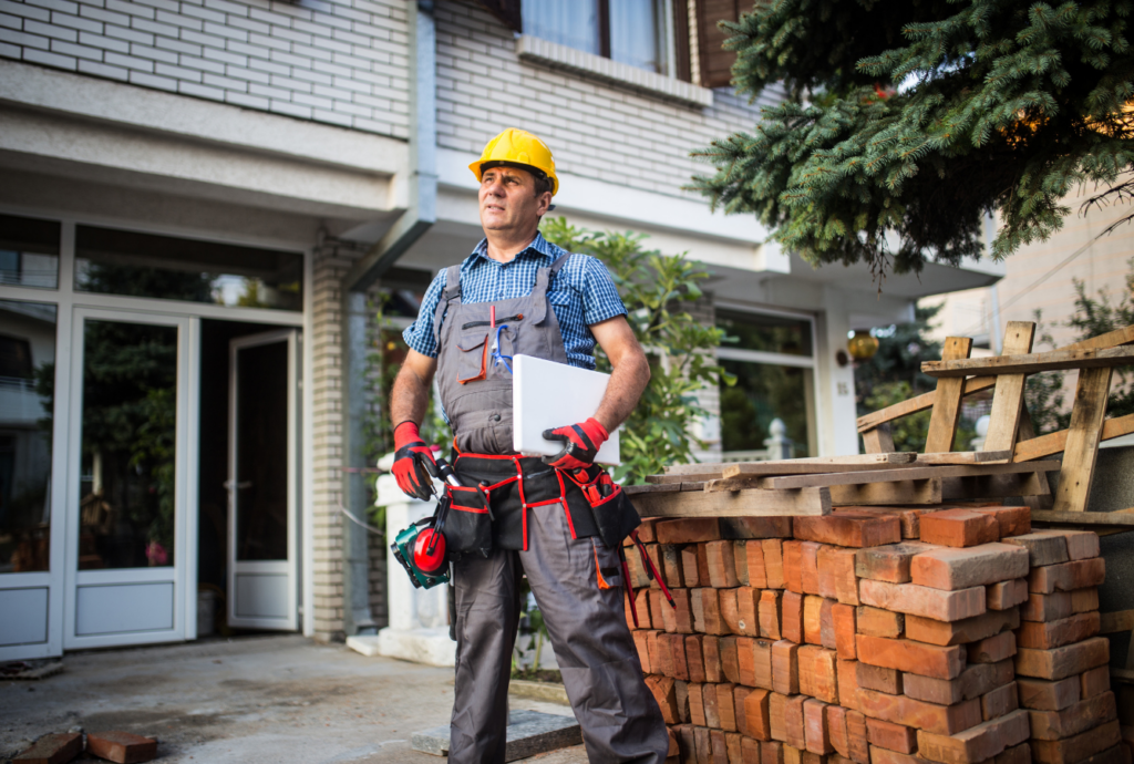 Man with hard hat and tool belt on a construction site