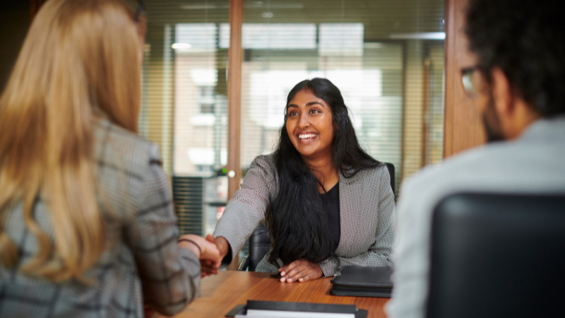 Young person shaking hands with interviewer