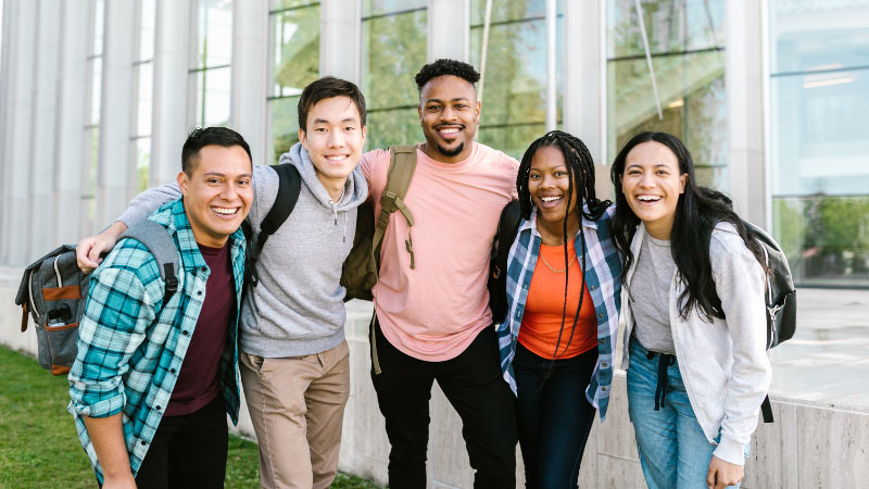 Group of university students stood together smiling