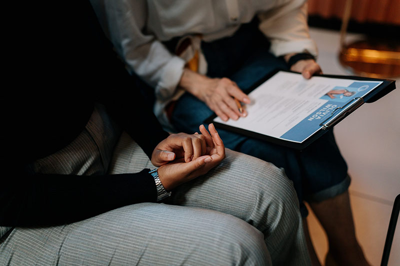 Two people sat together discussing a CV