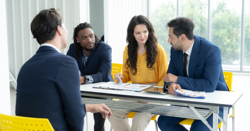 HR professionals sat around a table, having a discussion