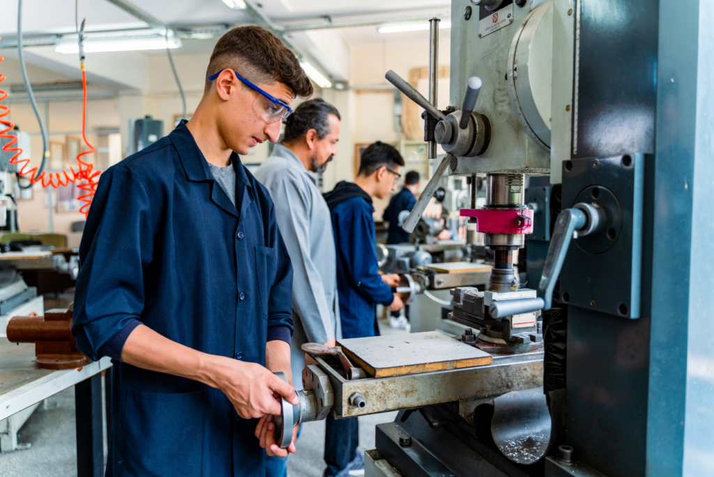 Young Engineer learning how to use tools in a workshop