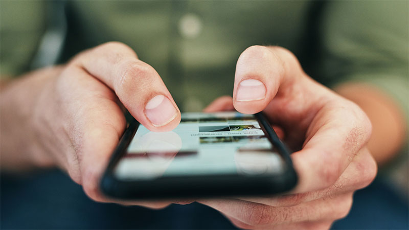 Close up of person scrolling on a mobile device