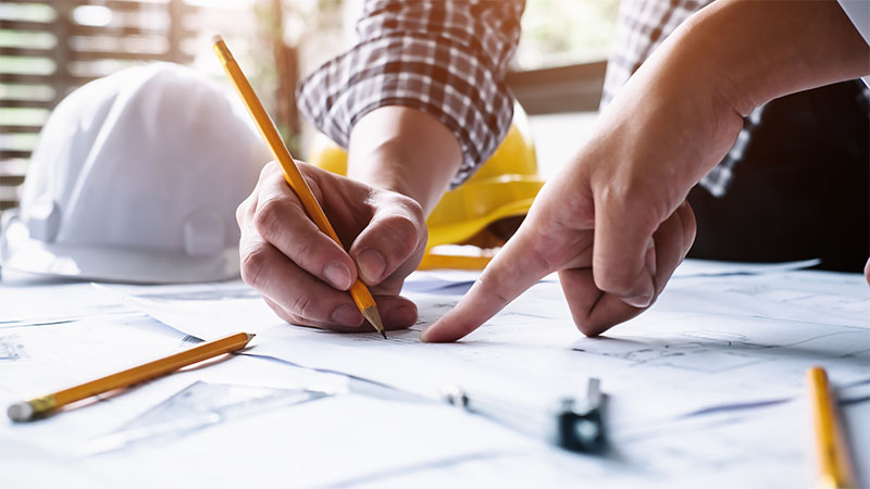 People working on construction plans