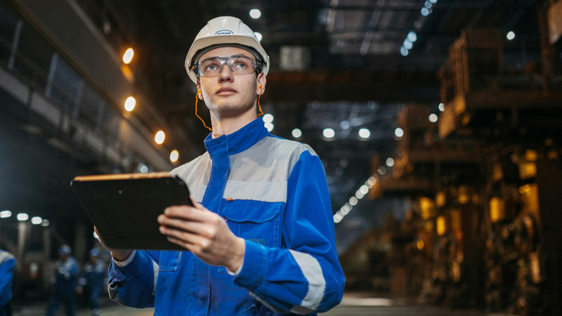 Engineer in Industrial Factory Using Tablet