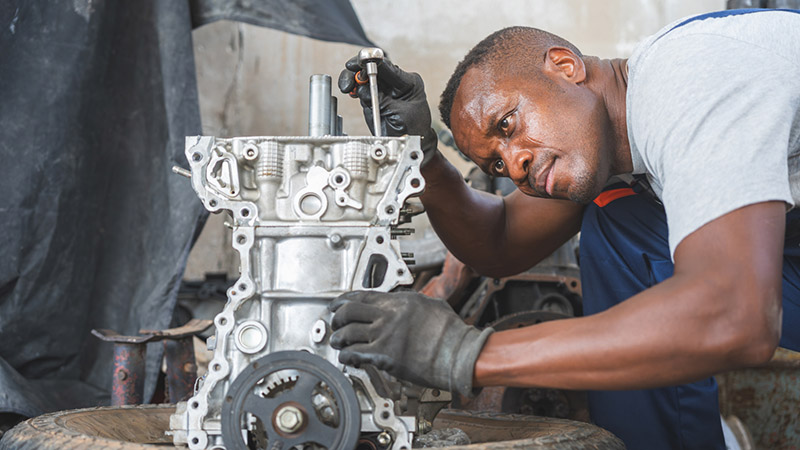 Mechanic Assembling Engine Parts in Garage, Auto Mechanic Working