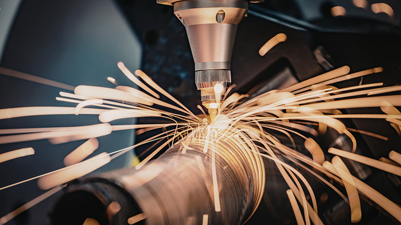 Precision laser cutting machine sparks flying in industrial setting