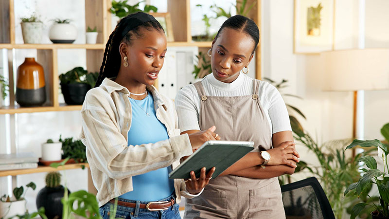 Two people reviewing plan inside office